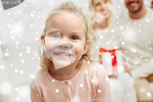 Image of happy family at home with christmas gift box