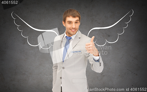 Image of businessman with angel wings showing thumbs up