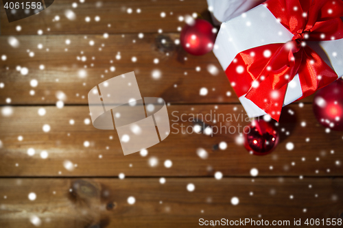Image of close up of gift boxes and red christmas balls