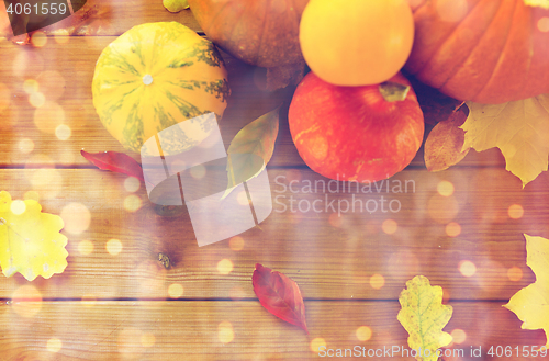 Image of close up of pumpkins on wooden table at home