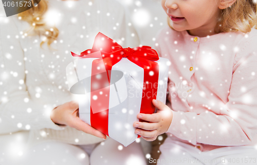 Image of close up of mother and little girl with gift box