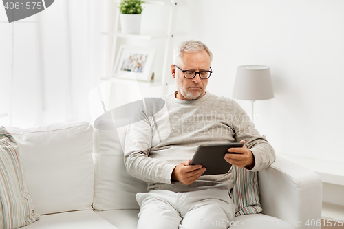 Image of senior man with tablet pc at home