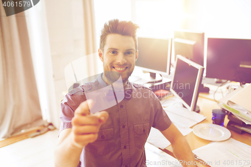 Image of happy male office worker pointing finger at you