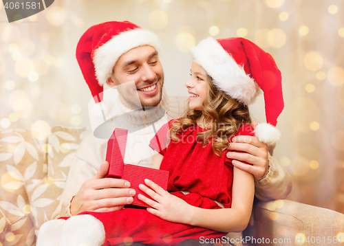 Image of smiling father and daughter opening gift box