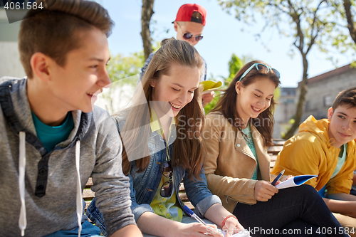Image of group of students with notebooks at school yard