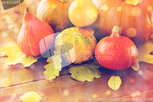 Image of close up of pumpkins on wooden table at home