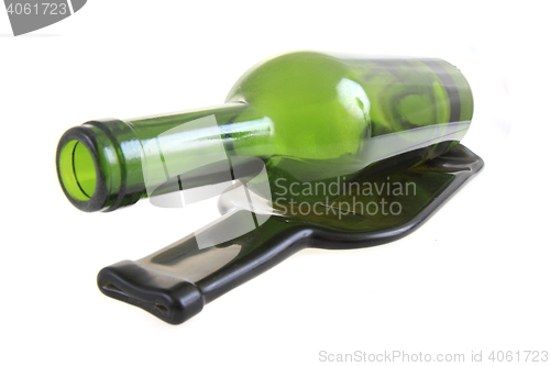 Image of green glass bottle with one flat bottle