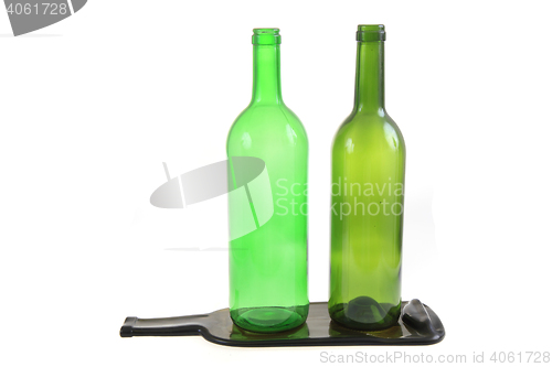 Image of green glass bottles with one flat bottle