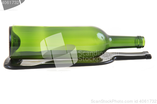 Image of green glass bottle with one flat bottle