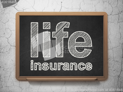 Image of Insurance concept: Life Insurance on chalkboard background