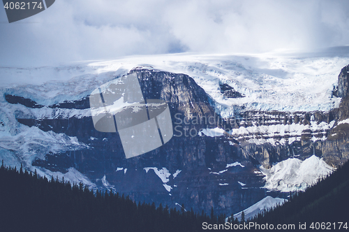 Image of Snow on mountains with clouds