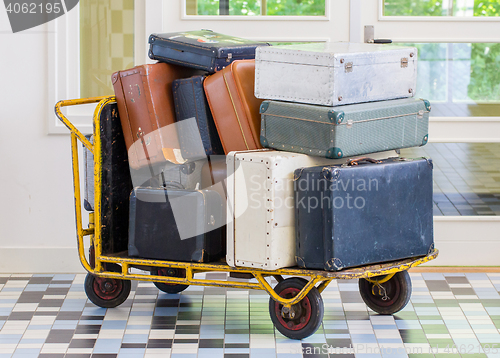 Image of Trolley full of old luggage