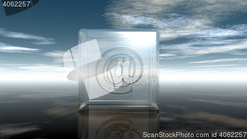 Image of email symbol in glass cube under cloudy sky - 3d rendering