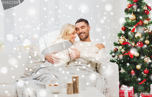 Image of happy couple at home with christmas tree