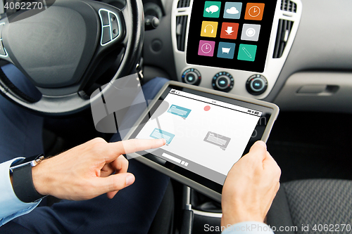 Image of close up of man with tablet pc in car