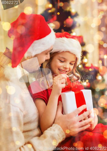 Image of smiling father and daughter opening gift box