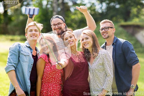 Image of friends taking selfie by smartphone at summer