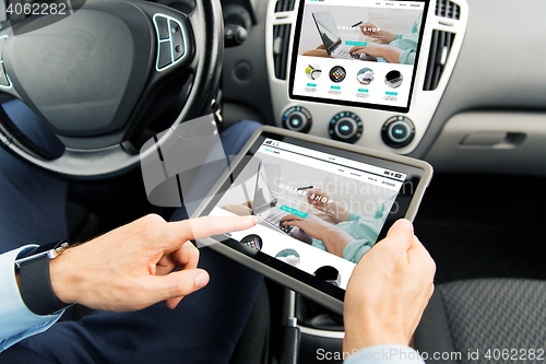 Image of close up of man with tablet pc in car