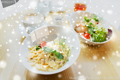 Image of close up of pasta in bowl on table at restaurant