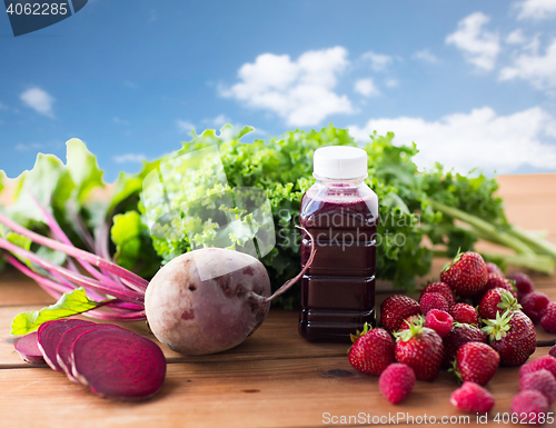 Image of bottle with beetroot juice, fruits and vegetables