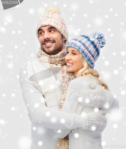 Image of smiling couple in winter clothes hugging