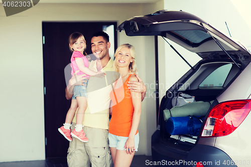 Image of happy family with hatchback car at home parking