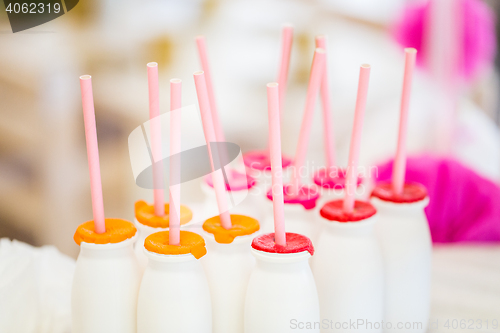 Image of close up of bottles with drinks and straws