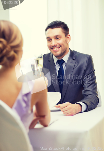 Image of couple with glasses of champagne at restaurant