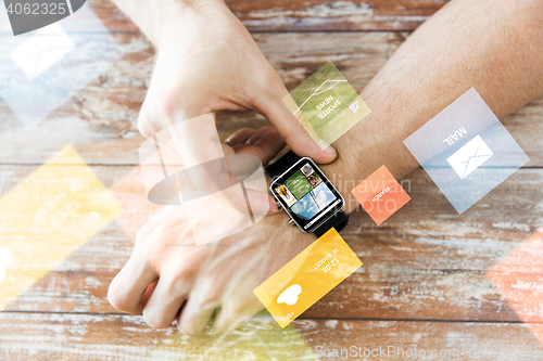 Image of close up of male hands setting smart watch