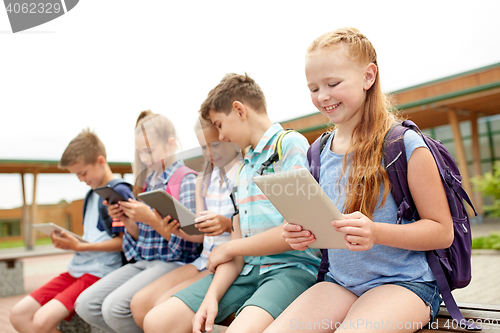 Image of group of happy elementary school students talking