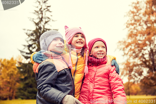 Image of group of happy children hugging in autumn park