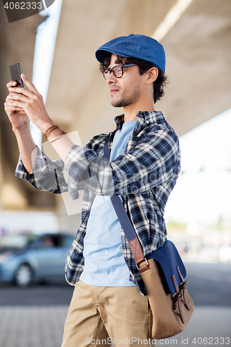 Image of hipster man taking selfie on smartphone