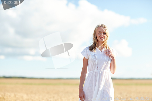 Image of happy young woman or teenage girl on cereal field