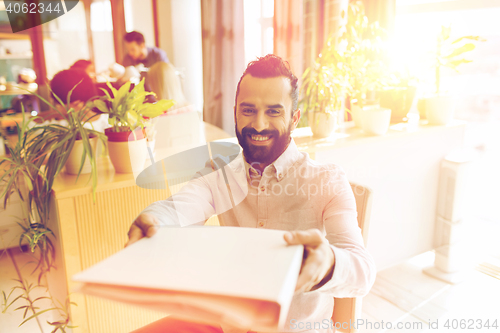 Image of happy creative male office worker with folfer