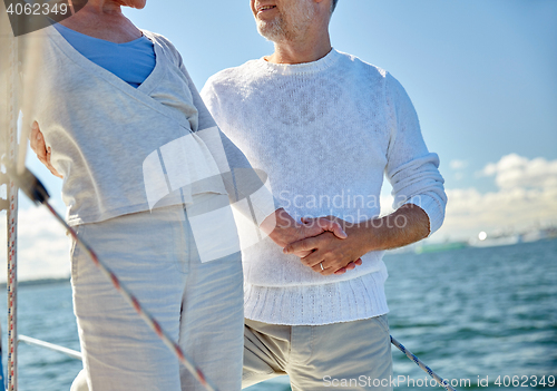 Image of happy senior couple on sail boat or yacht in sea