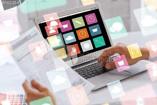 Image of businessman with laptop computer working at office