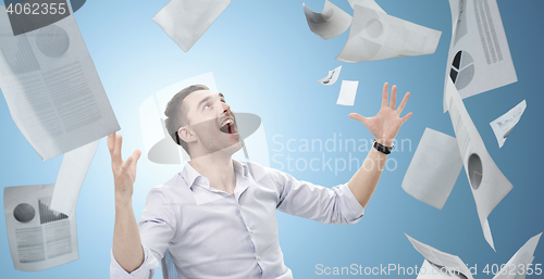 Image of businessman with falling papers