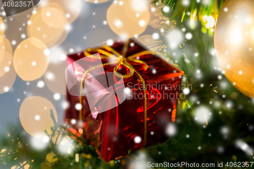 Image of close up of gift box decoration on christmas tree