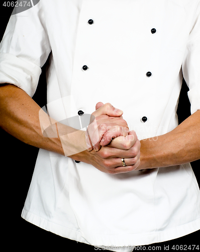 Image of Professional chef with a hand gesture towards, wearing a chefs j