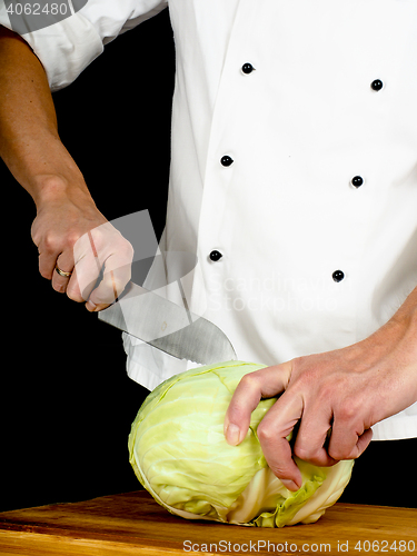 Image of Professional chef holding a sharp cooking knife onto a whole cab