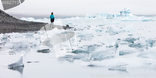 Image of Woman walking over the beach at Jokulsarlon glacier lagoon - Ice