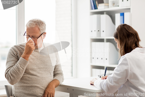 Image of senior man and doctor meeting at hospital