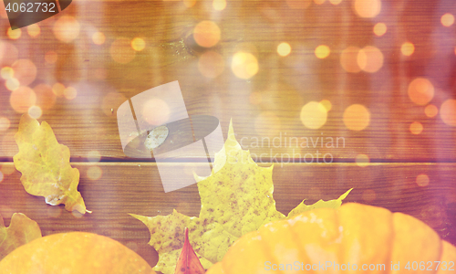 Image of close up of pumpkins on wooden table at home