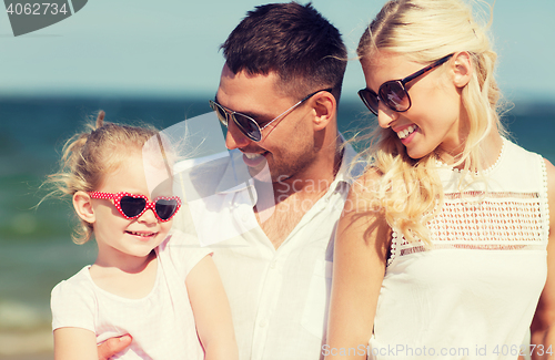 Image of happy family in sunglasses on summer beach