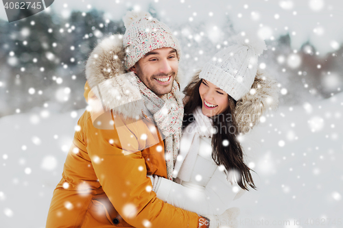 Image of happy couple hugging and laughing in winter