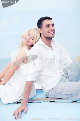 Image of couple in shades at sea side