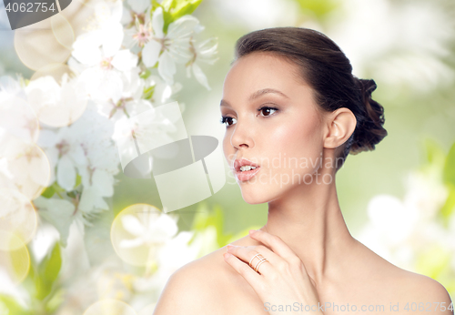 Image of face of beautiful asian woman with golden ring