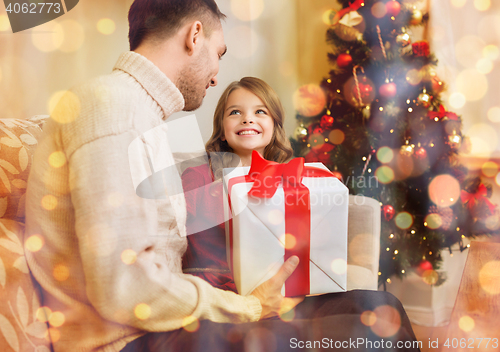 Image of smiling father and daughter looking at each other