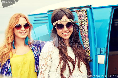 Image of smiling young hippie women over minivan car