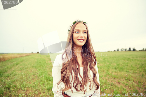 Image of smiling young hippie woman on cereal field